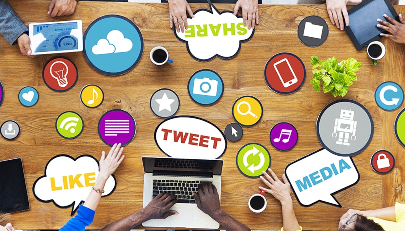multiple people sitting at table going over social media trends