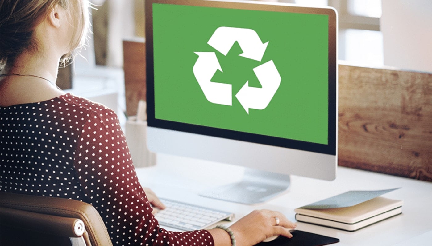 woman on computer with green recycling diagram on her computer