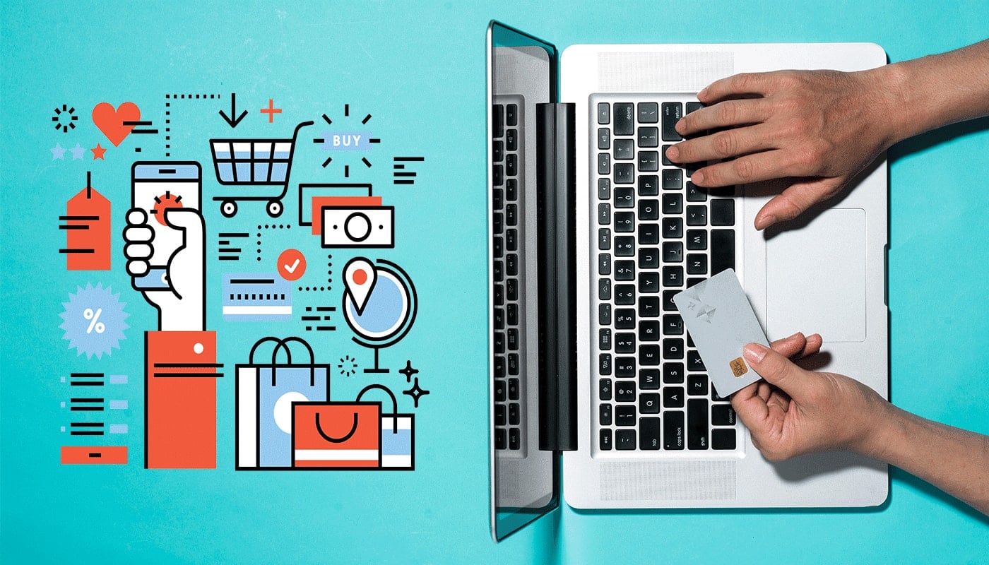 gentleman typing on computer with credit card in hand