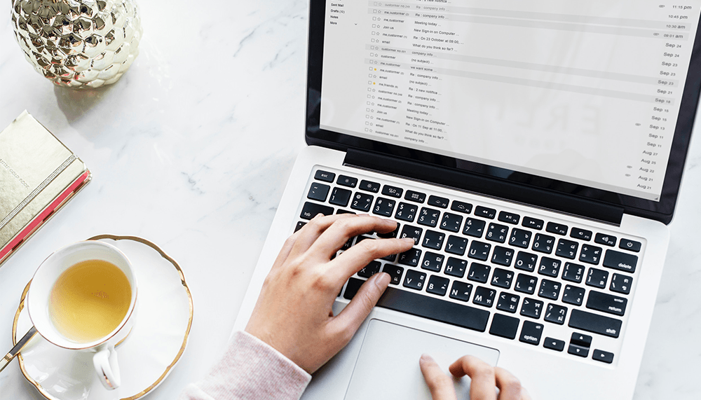 woman going through emails on her laptop