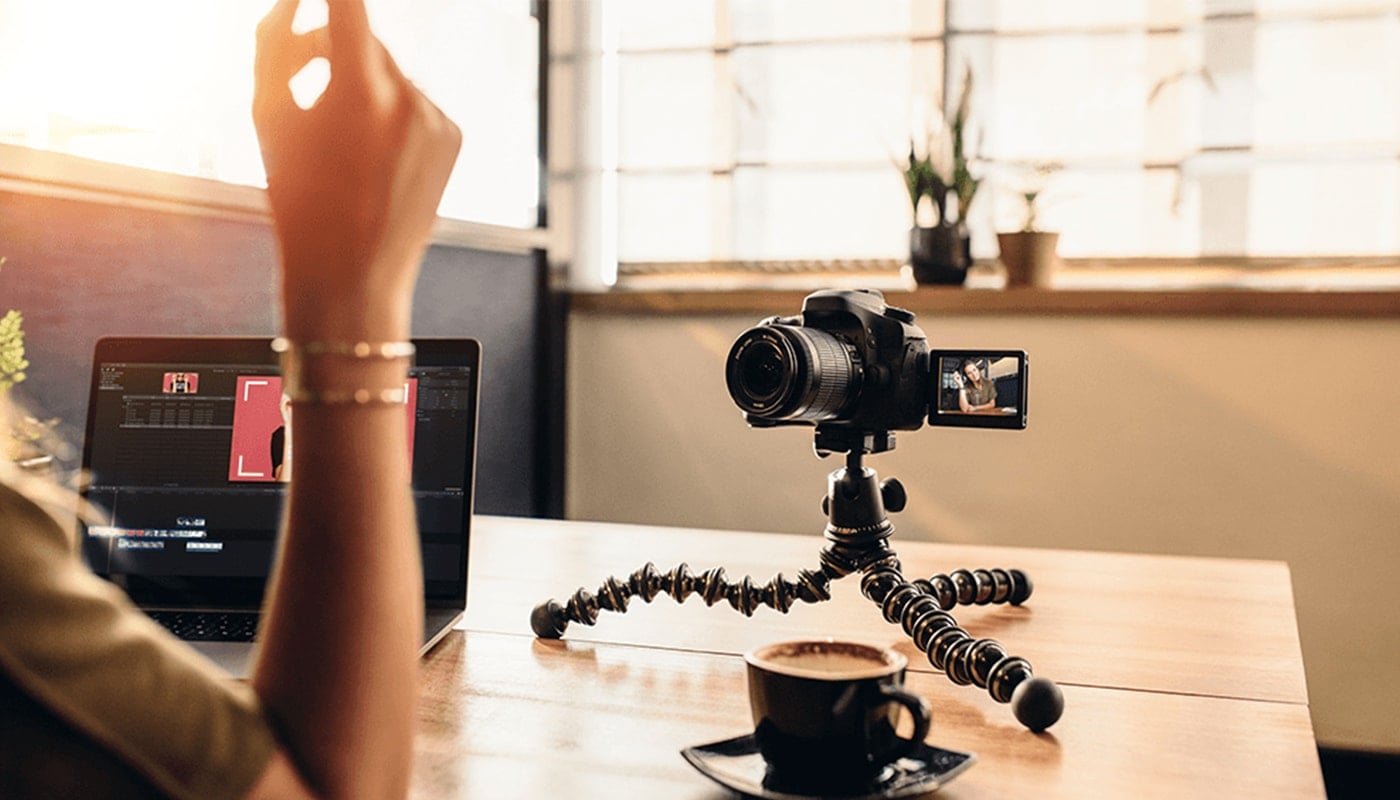 woman setting up her video camera on her laptop